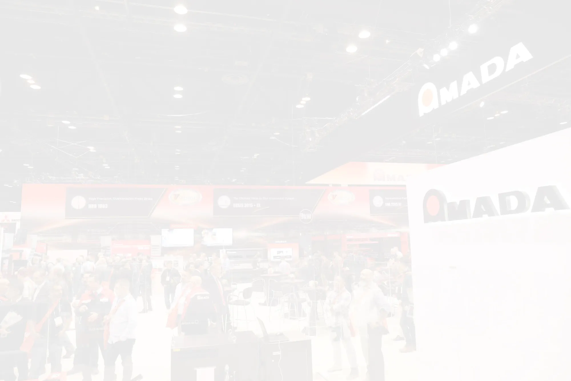 AMADA event calendar background showing trade show attendees