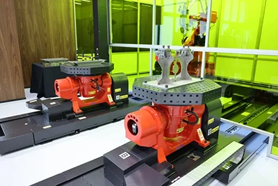 Dual rotary positioners with welded assemblies on fixture tables