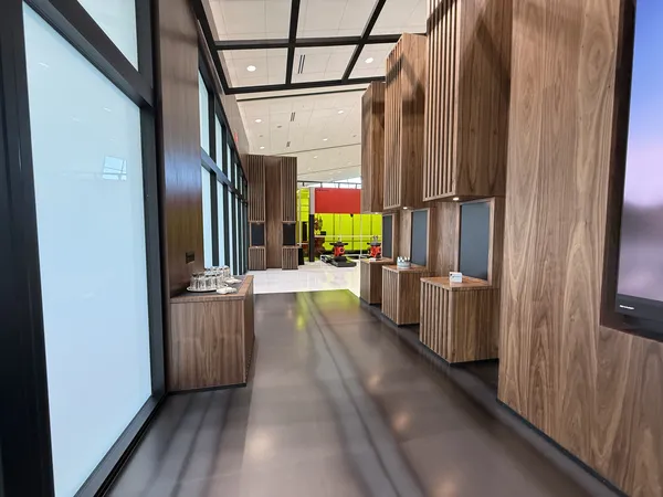 Walnut-clad corridor leading into the Welding Technology Zone